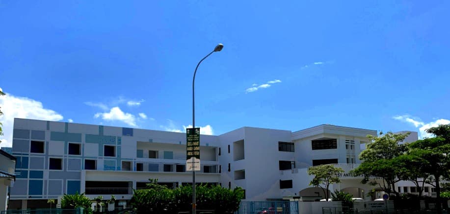 St. Anthony's Canossian Primary School St. Anthony's Canossian Primary School seen from Bedok North Avenue 4, its blue and white classroom blocks under a clear sky